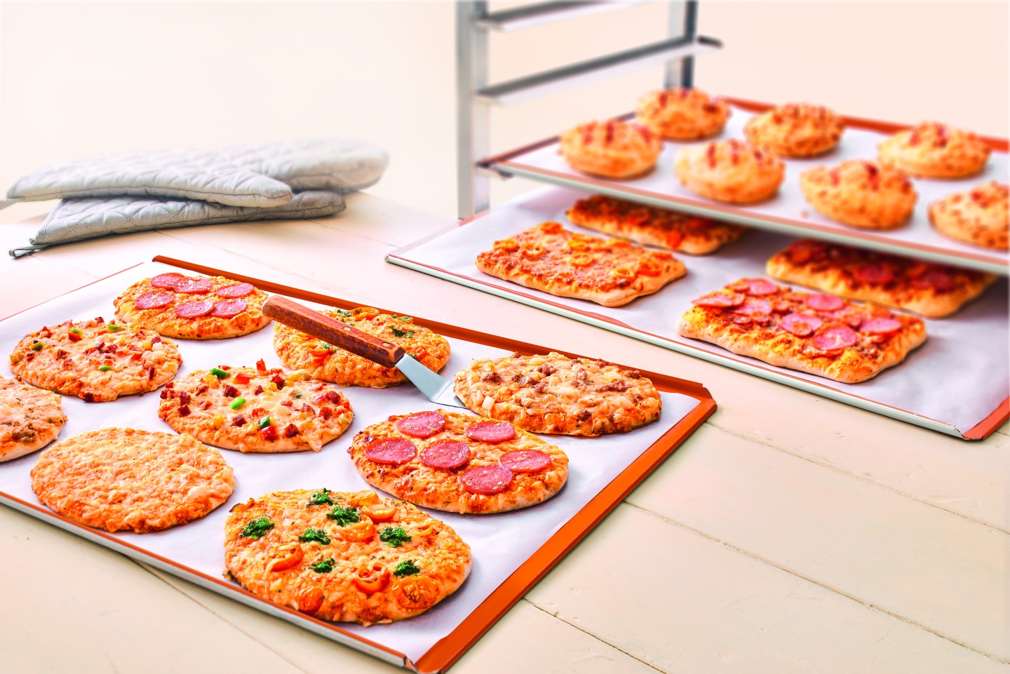 Various pizza snack varieties served on baking sheets.